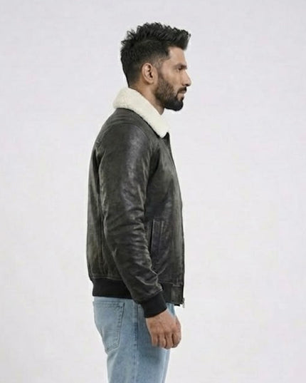 Man wearing a dark leather jacket with a white fur collar on a light gray background