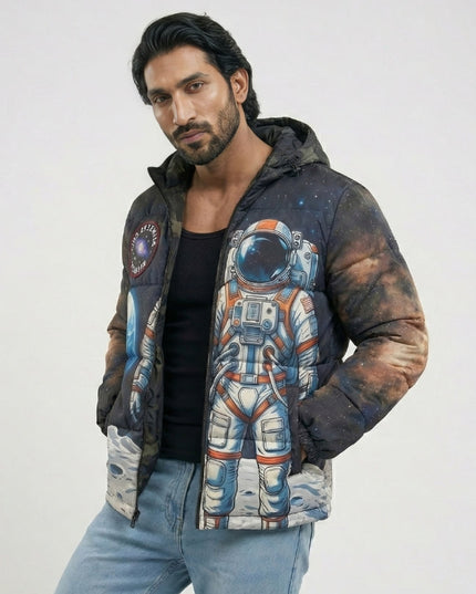 Man wearing a jacket with an astronaut design on a plain background