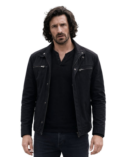 Man wearing a black jacket over a black shirt on a white background