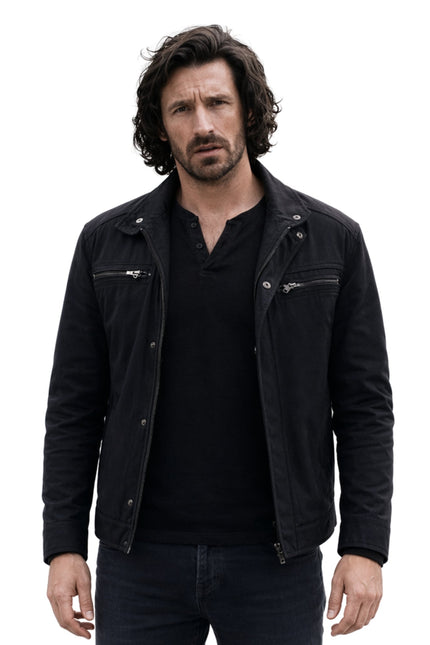 Man wearing a black jacket over a black shirt on a white background