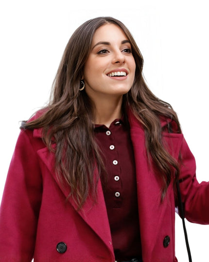Woman wearing a red coat on a white background