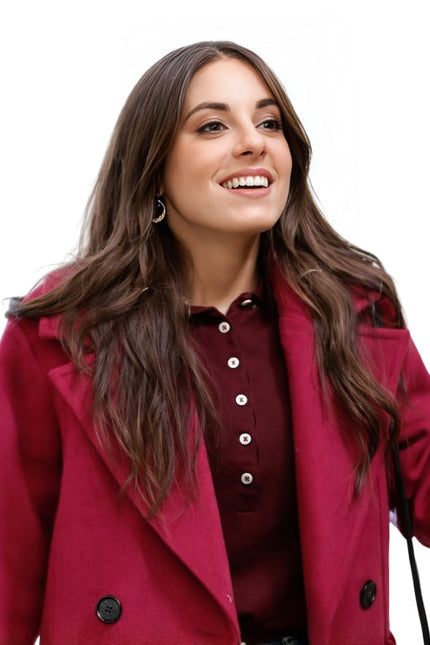 Woman wearing a red coat on a white background