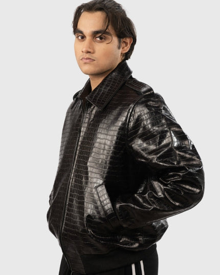 Man wearing a black crocodile-patterned leather jacket on a white background