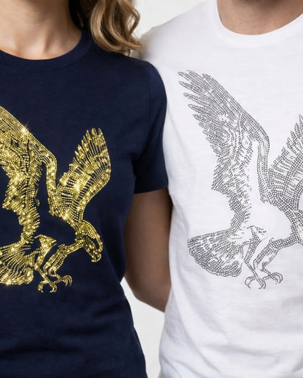 Two shirts with eagle designs, one gold on navy and one silver on white, worn by people.