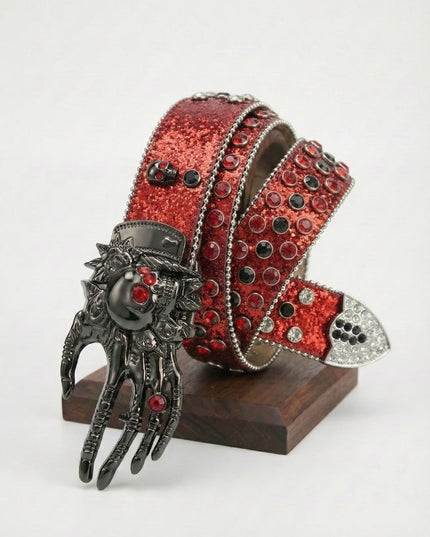 Red glittery belt with a decorative clasp on a white background