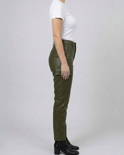 Person wearing green pants and a white shirt on a plain background