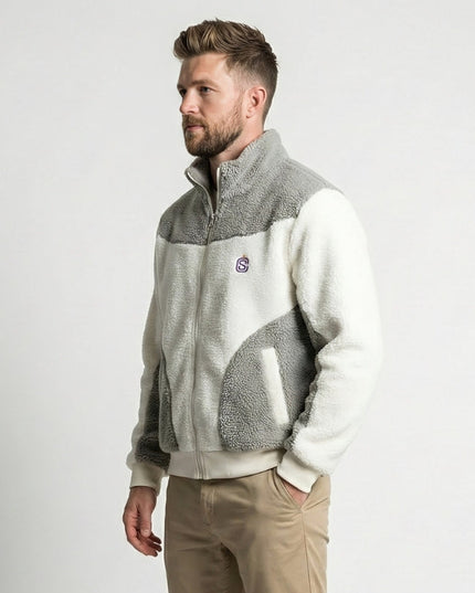 Man wearing a two-tone fleece jacket with a logo on a white background