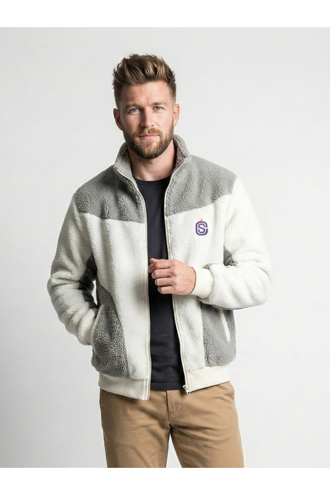 Man wearing a gray and white fleece jacket with a logo on a light gray background