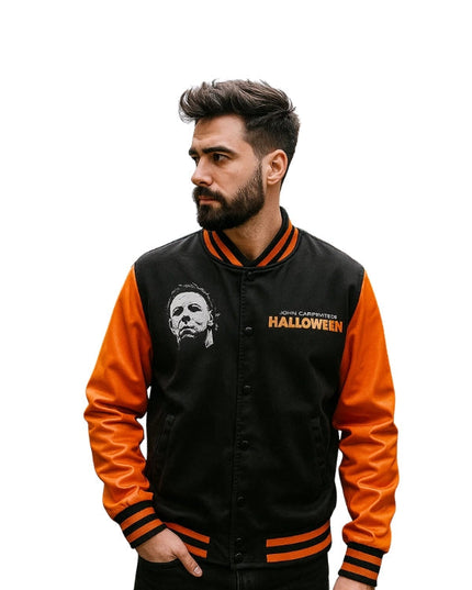 Man wearing a black and orange jacket with 'Halloween' text and logo.