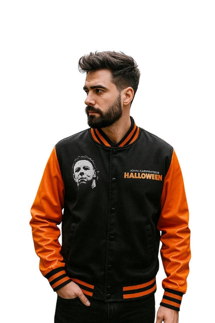 Man wearing a black and orange jacket with 'Halloween' text and logo.