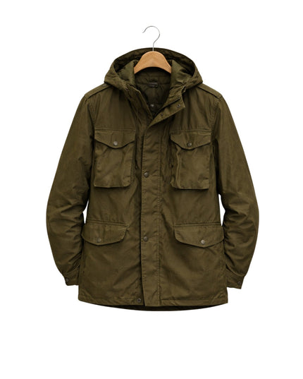 Green jacket with a hood on a hanger against a white background