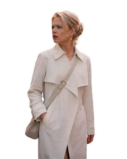 Woman wearing a beige trench coat on a white background