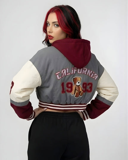 Person wearing a gray and red varsity jacket with 'California 1993' and a teddy bear design on a white background