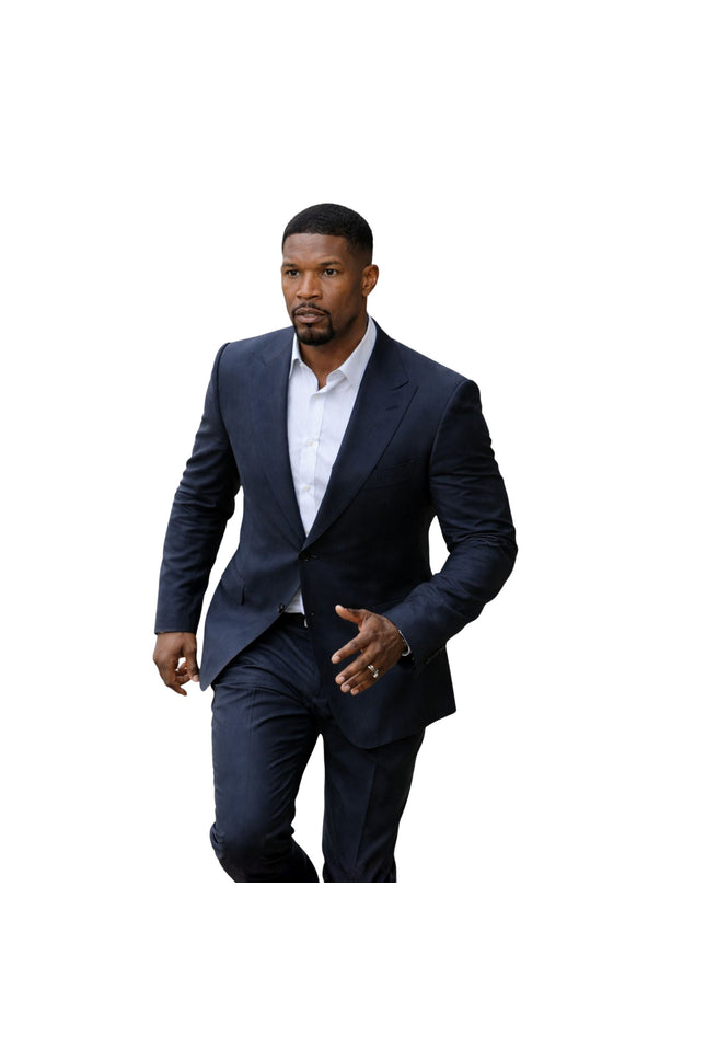 Man wearing a navy suit and white shirt on a white background