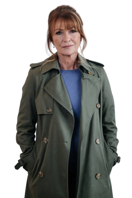 Woman wearing a green trench coat on a white background