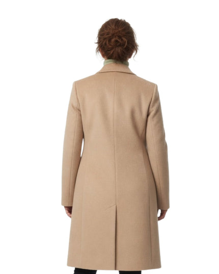 Person wearing a beige coat on a white background