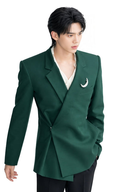 Person wearing a green blazer with a white shirt and black pants on a white background
