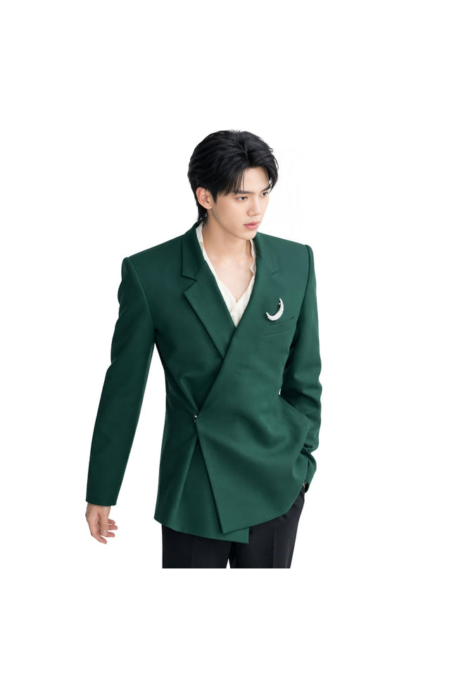 Person wearing a green blazer with a white shirt and black pants on a white background