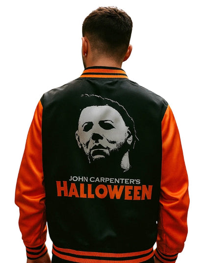 Person wearing a black and orange jacket with 'John Carpenter's Halloween' design on the back.