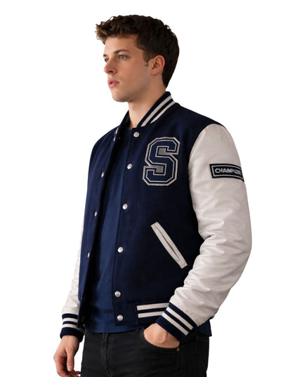 Man wearing a navy and white varsity jacket with a letter 'S' on a white background
