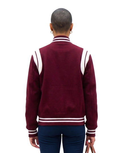 Person wearing a maroon varsity jacket with white stripes on a white background