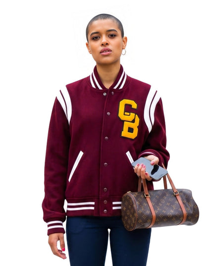 Person wearing a maroon varsity jacket with 'CB' lettering, holding a Louis Vuitton bag on a white background