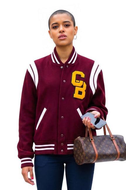 Person wearing a maroon varsity jacket with 'CB' lettering, holding a Louis Vuitton bag on a white background