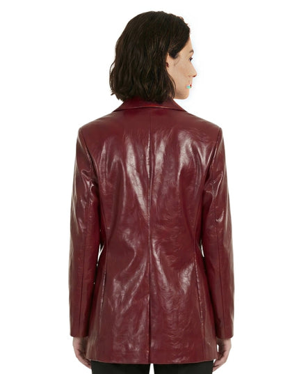 Woman wearing a shiny burgundy leather jacket on a white background