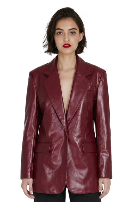 Woman wearing a burgundy leather jacket on a white background