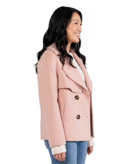 Person wearing a pink pea coat side ways 