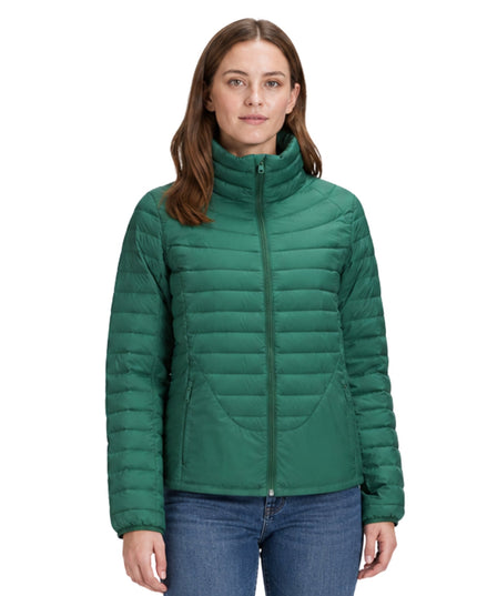 Woman wearing a green puffer jacket on a white background