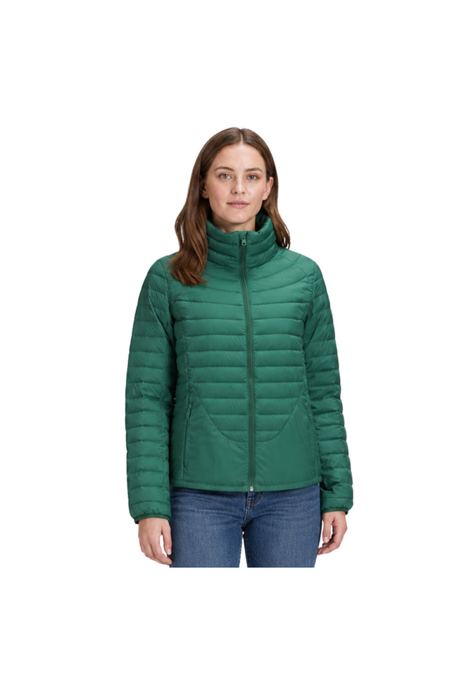 Woman wearing a green puffer jacket on a white background