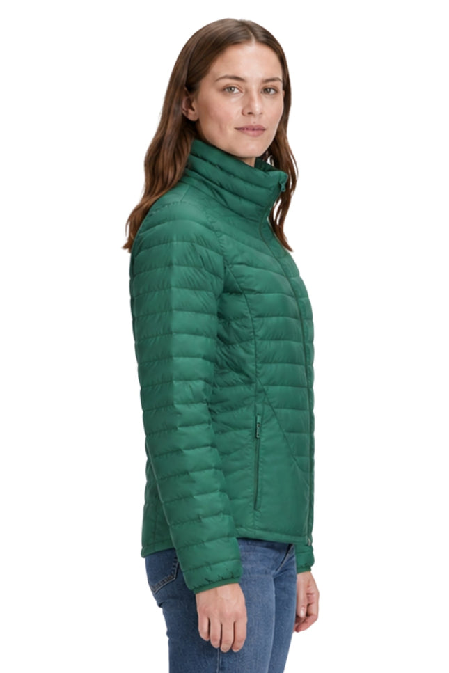 Woman wearing a green puffer jacket on a white background