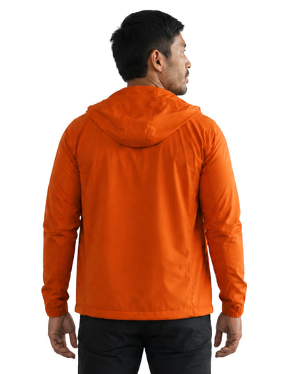 Person wearing an orange jacket on a white background