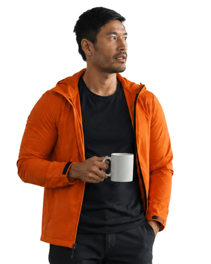 Man wearing an orange jacket holding a white mug on a white background