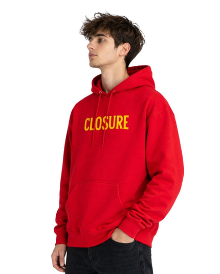Person wearing a red hoodie with 'CLOSURE' in yellow text on a white background
