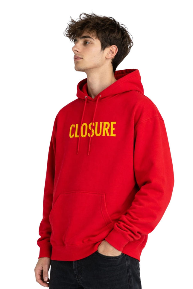Person wearing a red hoodie with 'CLOSURE' in yellow text on a white background