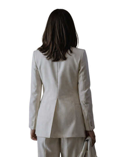 Woman wearing a beige suit on a white background