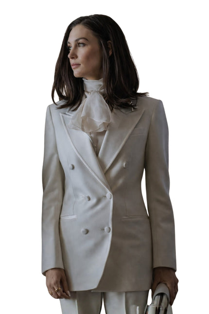 Woman wearing a two-tone blazer with a white background