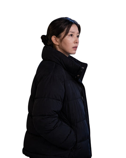 Person wearing a black puffer jacket on a white background