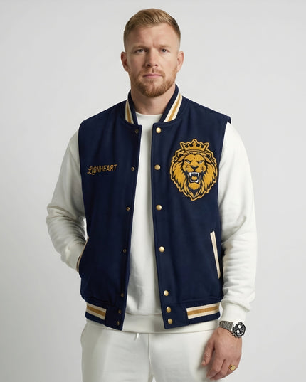 Man wearing a navy blue letterman jacket with a lion emblem on a white background