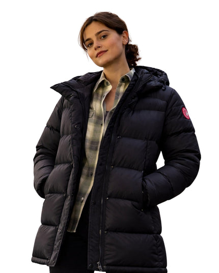 Woman wearing a black puffer jacket on a white background