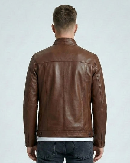 Man wearing a brown leather jacket on a light gray background