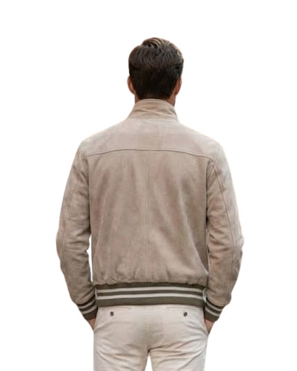 Man wearing a beige jacket with striped cuffs on a white background