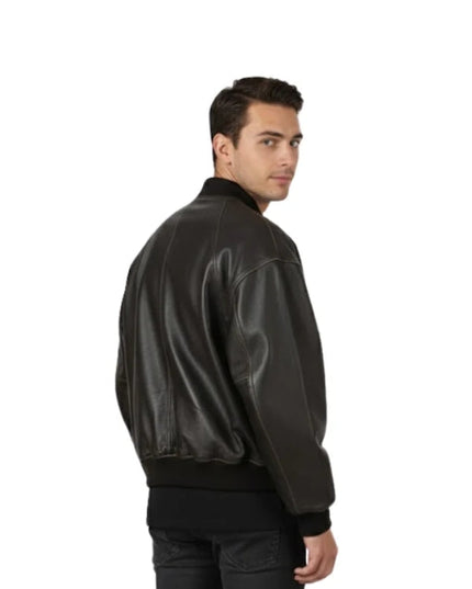 Man wearing a black leather bomber jacket on a white background