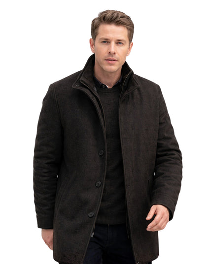 Man wearing a dark coat on a white background