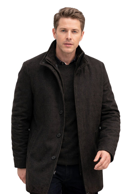Man wearing a dark coat on a white background