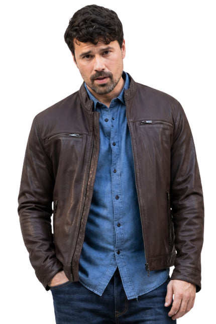 Man wearing a brown leather jacket over a blue shirt on a white background