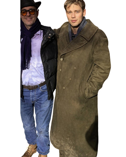 Two men, one wearing a black coat and sunglasses, the other in a long brown coat, on a white background.