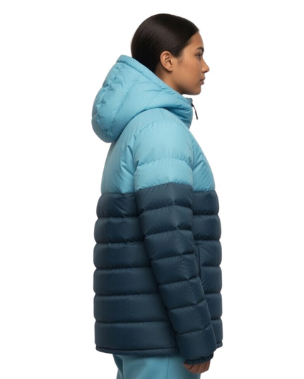 Person wearing a two-tone blue puffer jacket on a white background